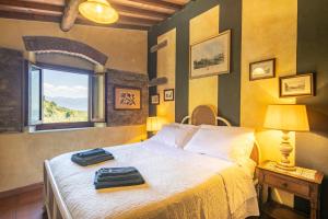 a bedroom with a bed with two bags on it at Casale Giaggiolo in Incisa in Valdarno