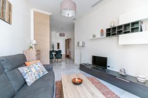a living room with a couch and a tv at Veoapartment Zaragoza in Seville