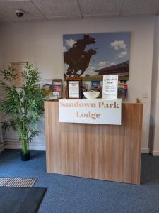 a sign for a stall in a store with a horse on it at Sandown Park Lodge in Esher