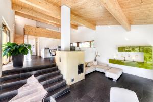 a living room with stairs and a fireplace at Panorama Chalet Bellavista in Brand