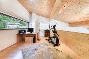 a room with a treadmill and a desk and a window at Panorama Chalet Bellavista in Brand +41 photos
