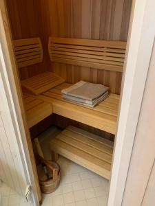 a sauna with wooden shelves and a book at Garmisch Lux Apartment mit Sauna in Garmisch-Partenkirchen
