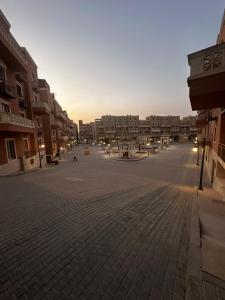 an empty street in a city with buildings at Hotel Apartment New Cairo in Cairo