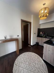 a living room with a large rug and a kitchen at Hotel Apartment New Cairo in Cairo