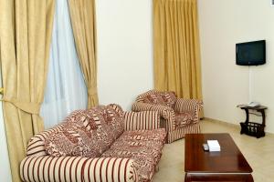 a living room with two couches and a coffee table at Sara Hotel Apartments in Ajman  +16 photos