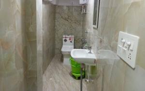a bathroom with a sink and a toilet at Super Hotel O City Inn in Ayodhya