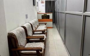 a row of chairs in a waiting room at Super Hotel O City Inn in Ayodhya