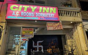a store with a sign on the front of it at Super Hotel O City Inn in Ayodhya