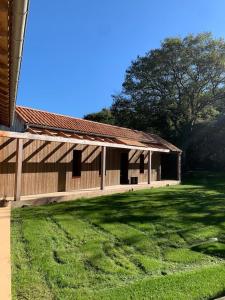 a large building with a grassy yard in front of it at la maison des Poteries in Chanteloup-les-Bois