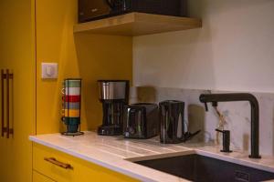 a kitchen with a sink and a counter top at la maison des Poteries in Chanteloup-les-Bois