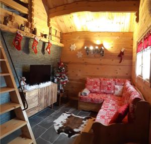 a living room with a couch in a log cabin at Chalet L' ADRET in Bluffy