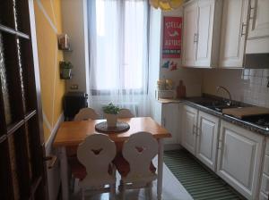 a kitchen with a table and chairs and a window at Lemon Green House in Riva del Garda