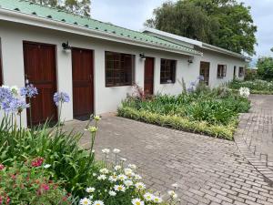 a house with flowers in front of it at Farmlands Guesthouse in George