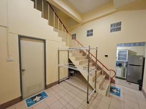 a spiral staircase in a room with a refrigerator at My Home Central Hatyai - Whole house - 18pax in Sathani Khlong Rian