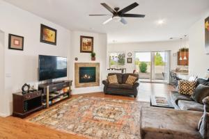 a living room with a fireplace and a tv at Cozy Granville Retreat with Modern Amenities, nearby Scenic Trails & Pristine Lakes of Prescott home in Prescott Valley +41 photos