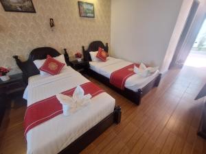 Postel nebo postele na pokoji v ubytování Luang Prabang Pavilion Hotel & Travel