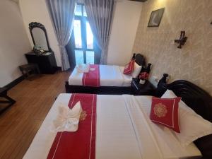 Postel nebo postele na pokoji v ubytování Luang Prabang Pavilion Hotel & Travel