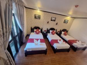 Postel nebo postele na pokoji v ubytování Luang Prabang Pavilion Hotel & Travel