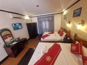 Postel nebo postele na pokoji v ubytování Luang Prabang Pavilion Hotel & Travel