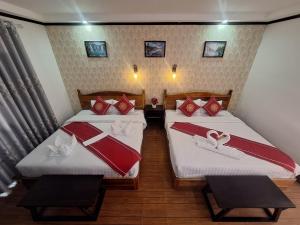 Postel nebo postele na pokoji v ubytování Luang Prabang Pavilion Hotel & Travel