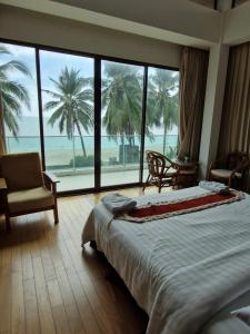 Postel nebo postele na pokoji v ubytování Palmeraiebeach Resort Rayong ปาล์มมาลี บีช รีสอร์ท ระยอง 罗勇棕榈树海滩酒店