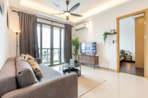 a living room with a couch and a tv at SeaView R&F 4pax-1BR 10mis to CIQ JBSentral CitySquare in Johor Bahru