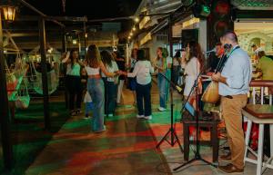 a man standing in a room with a crowd of people at Philoxenia Hotel & SPA in Malia +37 photos