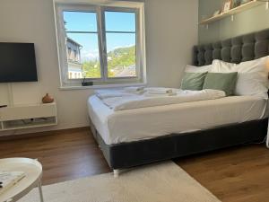 a bedroom with a large bed with a large window at Ferienwohnung Millstatt in Millstatt