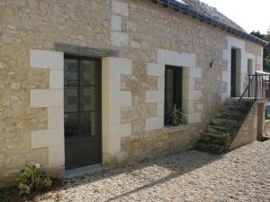 a stone building with a door and a staircase at Châteaux de la Loire - Près de Tours - Cottage EAU CALME en Bord de Lac in Saint-Avertin