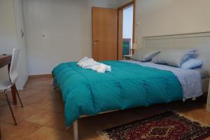 a bedroom with a bed with towels on it at Swiss Bliss Heaven in Roveredo +38 photos