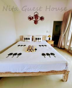Postel nebo postele na pokoji v ubytování Nita Guest House Bali