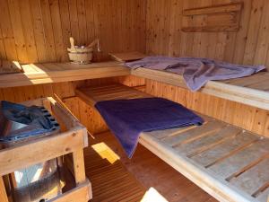 an inside of a wooden cabin with two beds at Ferienhaus Celeste in Warnemünde