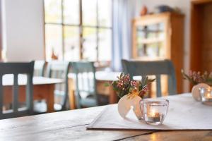 a table with a napkin with a candle and a glass at Gasthof Alex in Weißenbrunn