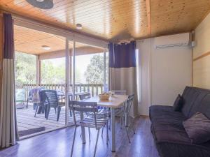 a living room with a couch and a table and chairs at Chalet 3 étoiles - eeicci in Cargèse