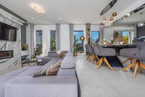 a living room with a couch and a grand piano at Villa Nina ZadarVillas in Zaton