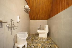 a bathroom with a toilet and a sink at The Riverwalk in Gushaini