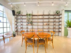 a dining room with a wooden table and chairs at Beat Hotel Bangkok in Bangkok