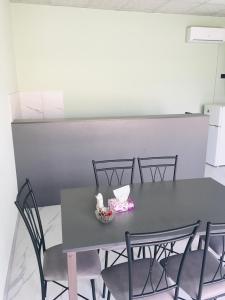 a gray table with chairs and a bowl of flowers on it at Bardy guest house in Chʼiva