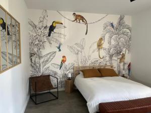 a bedroom with a mural of birds on the wall at LA GRANGE in Anzin-Saint-Aubin