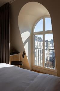 Ένα ή περισσότερα κρεβάτια σε δωμάτιο στο Hôtel Cabane - Orso Hotels