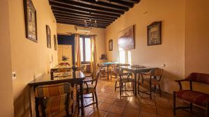a restaurant with tables and chairs in a room at Hotel La Casa Grande del Burgo in El Burgo +23 photos