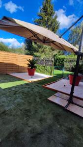 a picnic table with an umbrella in a yard at Deauville Bonny and clyde room in Valsemé