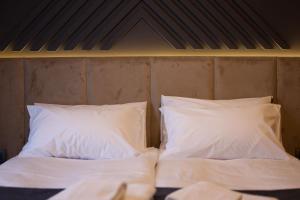 Ένα ή περισσότερα κρεβάτια σε δωμάτιο στο Nest Suites