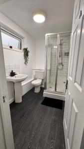 um banheiro com vaso sanitário, pia e chuveiro em Spacious sheffield lodge em Sheffield