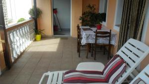 a balcony with a table and chairs in a room at Apartment Ralje in Sali