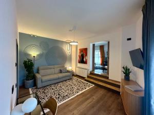 a living room with a couch and a table at JADE - guesthouse in Buzău