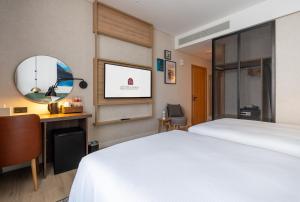 Vuode tai vuoteita majoituspaikassa West Walk Retaj Hotel