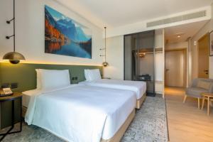 Vuode tai vuoteita majoituspaikassa West Walk Retaj Hotel