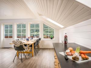 a kitchen with a table with a plate of vegetables on it at Holiday Home Frigg by Interhome in Arnefjord