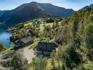 a house on a hill next to a body of water at Holiday Home Frigg by Interhome in Arnefjord